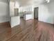 Open kitchen area with white cabinetry, granite countertops, and hardwood floors at 503 Middleton Blvd, Summerville, SC 29485