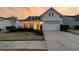 Charming single-Gathering home with a two-car garage and manicured lawn at sunset at 520 Tranquil Waters Way, Summerville, SC 29486