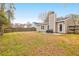 Fenced backyard with a mix of grass and bare spots, featuring a patio with outdoor seating at 536 Castle Hall Rd, Mount Pleasant, SC 29464