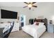 Bright bedroom featuring a ceiling fan, a large bed, and access to an ensuite bathroom at 536 Castle Hall Rd, Mount Pleasant, SC 29464