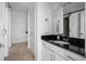 Modern bathroom with black granite countertop, white vanity, and designer fixtures at 700 Daniel Ellis Dr # 8108, Charleston, SC 29412