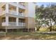 Exterior of building with covered balconies, white railings and well-maintained lawn at 700 Daniel Ellis Dr # 8108, Charleston, SC 29412