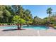 Picturesque community pool area with swaying palm trees, comfortable lounge chairs, and ample space for relaxation at 700 Daniel Ellis Dr # 8108, Charleston, SC 29412