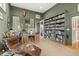 Spacious home office featuring a wall of books, eclectic furnishings, and access to the porch at 707 Glossy Ibis Ln, Kiawah Island, SC 29455