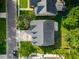 Aerial view of a residential home with a well-manicured lawn, mature trees, and a driveway at 7217 Mossy Creek Ln, Hanahan, SC 29410
