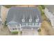 Aerial view of the home featuring a covered porch, attached garage, and mature trees at 7217 Mossy Creek Ln, Hanahan, SC 29410