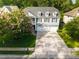 Two-story home with a three-car garage, surrounded by mature trees and a well-maintained yard at 7217 Mossy Creek Ln, Hanahan, SC 29410