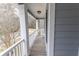This home features a back porch with white pillars and a railing overlooking the yard at 7217 Mossy Creek Ln, Hanahan, SC 29410