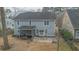 Backyard view with a screened porch and patio surrounded by mature trees and lawn at 7217 Mossy Creek Ln, Hanahan, SC 29410