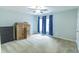 Bright bedroom features a ceiling fan, natural light, and light-colored walls and carpet at 7217 Mossy Creek Ln, Hanahan, SC 29410