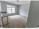 A vacant bedroom with carpeted floors, light blue walls, and a window at 7217 Mossy Creek Ln, Hanahan, SC 29410