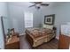 Cozy bedroom featuring a quilt bedspread, wood floors and a ceiling fan at 7217 Mossy Creek Ln, Hanahan, SC 29410
