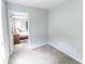 Bright bedroom with neutral carpet, and a view of the adjacent bedroom at 7217 Mossy Creek Ln, Hanahan, SC 29410