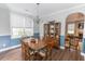 Formal dining room with a large window, wainscotting, and a chandelier over the wood table at 7217 Mossy Creek Ln, Hanahan, SC 29410