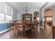Formal dining room with a large window, wainscotting, and a chandelier over the wood table at 7217 Mossy Creek Ln, Hanahan, SC 29410