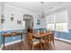 Formal dining room with a large window, wainscotting, and a chandelier over the wood table at 7217 Mossy Creek Ln, Hanahan, SC 29410