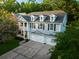 Inviting two-story home with a three-car garage, complemented by a charming balcony and lush landscaping at 7217 Mossy Creek Ln, Hanahan, SC 29410