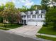 Attractive two-story home boasting a three-car garage, a welcoming front porch, and a well-manicured lawn at 7217 Mossy Creek Ln, Hanahan, SC 29410