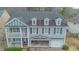 Home featuring a welcoming front porch and a two-car garage with a second story at 7217 Mossy Creek Ln, Hanahan, SC 29410