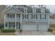 Charming two-story home featuring a front porch, balcony, dormer windows, and a spacious three-car garage at 7217 Mossy Creek Ln, Hanahan, SC 29410