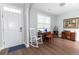 Inviting foyer area featuring hardwood floors, fresh white paint, and a rocking chair to greet guests at 7217 Mossy Creek Ln, Hanahan, SC 29410