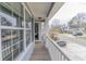 This home features a long front porch with white pillars, a railing, and shade at 7217 Mossy Creek Ln, Hanahan, SC 29410