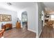 Hallway between formal dining and Gathering room with hardwood floors and decorative archways connecting rooms at 7217 Mossy Creek Ln, Hanahan, SC 29410