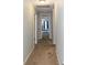 Hallway with neutral carpeting, fresh paint, and access to rooms with ample natural light at 7217 Mossy Creek Ln, Hanahan, SC 29410