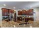 An open kitchen with stainless steel appliances and a large granite breakfast bar at 7217 Mossy Creek Ln, Hanahan, SC 29410