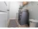A spacious laundry room features tile floor, full-size appliances, and ample storage at 7217 Mossy Creek Ln, Hanahan, SC 29410