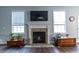 A fireplace with white mantle flanked by windows at 7217 Mossy Creek Ln, Hanahan, SC 29410