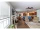 Open-concept living room leading to a modern kitchen with stainless steel appliances and a breakfast bar at 7217 Mossy Creek Ln, Hanahan, SC 29410