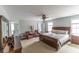 A large, bright main bedroom features a ceiling fan, carpet, and warm paint at 7217 Mossy Creek Ln, Hanahan, SC 29410