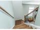View of the staircase from the top with wood treads, white risers and dark wood railing at 7217 Mossy Creek Ln, Hanahan, SC 29410