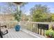 Relaxing covered balcony features white railings, an outdoor chair, and vibrant plant decorations at 9309 Sweetbay Ct, Ladson, SC 29456