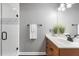 Bright bathroom with a glass shower, neutral-colored tiles, and wooden vanity at 9309 Sweetbay Ct, Ladson, SC 29456