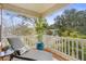 Relaxing covered porch with chaise lounge and a view of lush greenery and blue sky at 9309 Sweetbay Ct, Ladson, SC 29456