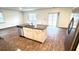 Open concept kitchen featuring an island with granite counters and stainless steel dishwasher at 9724 Roseberry St, Ladson, SC 29456