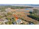 An aerial view of a waterfront home featuring a pool, marsh views, and mature trees at 1075 Avenue Of Oaks, Charleston, SC 29407