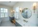 Bright bathroom with dual vanities, gold fixtures, and star themed wallpaper at 1075 Avenue Of Oaks, Charleston, SC 29407