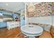 Bright dining area with a chandelier, floral wallpaper, and view of the light-blue kitchen at 1075 Avenue Of Oaks, Charleston, SC 29407