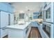 Bright and airy kitchen with light blue cabinets, a center island, and stainless steel appliances at 1075 Avenue Of Oaks, Charleston, SC 29407