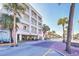 Hotel exterior showing balcony views, covered parking and tropical landscaping at 1126 Ocean Blvd # 116, Isle of Palms, SC 29451