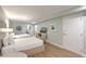 Bedroom with two beds, TV and view into bathroom with toilet and sink at 1126 Ocean Blvd # 203, Isle of Palms, SC 29451