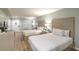 This bedroom has two beds, a table and chair, and a flat screen TV at 1126 Ocean Blvd # 203, Isle of Palms, SC 29451