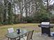 Outdoor patio area with a grill and seating, perfect for dining and enjoying the peaceful backyard setting at 113 Ford Ct, Summerville, SC 29483