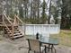 Backyard with a above ground pool and a wooden deck area, offering a private space for relaxation and entertainment at 113 Ford Ct, Summerville, SC 29483