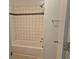 A tiled bathtub and shower combo with a decorative tile accent, offering a clean and functional space at 113 Ford Ct, Summerville, SC 29483