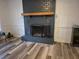 Cozy living room featuring a painted brick fireplace with a wooden mantel and a decorative fire screen at 113 Ford Ct, Summerville, SC 29483