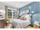 Comfortable bedroom with hardwood floors, chic wainscoting and trim, and windows offering great outdoor views at 1168 Reserve Ln, Awendaw, SC 29429